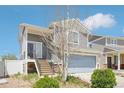 Charming two-story home with a two-car garage and staircase leading to the front door at 5571 Killarney St, Denver, CO 80249