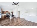A spacious living room and kitchen are shown with wood floors and white walls at 5571 Killarney St, Denver, CO 80249