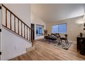 Bright dining area with hardwood floors and glass-top dining table at 2697 S Deframe Cir, Lakewood, CO 80228