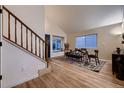 Bright dining area featuring a vaulted ceiling, wood floors, and a cozy window nook at 2697 S Deframe Cir, Lakewood, CO 80228