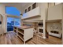 Open living space with island, fireplace, large windows, and access to the deck at 2697 S Deframe Cir, Lakewood, CO 80228