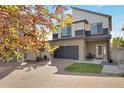 Charming two-story home featuring neutral tones, modern architectural detail, and a brick driveway at 17838 E 54 Th Ave, Denver, CO 80249