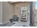 Inviting front porch featuring neutral tones, a glass door, and a Hello door mat at 17838 E 54 Th Ave, Denver, CO 80249