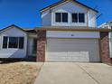 Well-maintained two-story home with attached garage, brick facade, and inviting curb appeal at 84 S Carlton St, Castle Rock, CO 80104