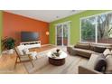 Bright living room boasts hardwood floors, and sliding door access to a private balcony at 1241 S Akron Way, Denver, CO 80247
