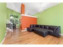 Spacious living room features vaulted ceilings, hardwood floors, and a modern chandelier at 1241 S Akron Way, Denver, CO 80247