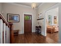 Elegant foyer with a hardwood floor, wooden front door, and adjacent living room view at 5675 S Crocker St, Littleton, CO 80120
