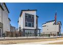 Contemporary three-story house showcasing a stylish exterior with large windows and modern architectural elements at 10863 E Hinsdale Cir, Centennial, CO 80112