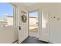 Bright foyer featuring tile flooring, a decorative wreath, and a clear view of the front yard at 7309 W Hampden Ave # 6103, Lakewood, CO 80227