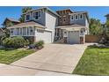 Stylish two-story home with a wide driveway and well-maintained lawn and landscaping at 11074 Grayledge Cir, Highlands Ranch, CO 80130