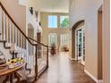 Grand foyer featuring soaring ceilings, hardwood floors, and an elegant staircase at 11074 Grayledge Cir, Highlands Ranch, CO 80130