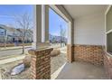 Brick front porch with view of a residential street at 5833 N Biscay St, Denver, CO 80249