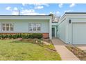 Well-maintained exterior of single story home with vibrant green lawn and manicured flower beds at 1420 E Bates Ave, Englewood, CO 80113