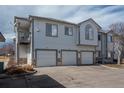 Well-maintained exterior view of a condo featuring a multi-car garage and a private balcony at 3242 E 103Rd Dr # 602, Thornton, CO 80229