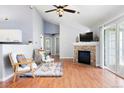 Bright living room with fireplace, ceiling fan, and sliding door access to the balcony at 3242 E 103Rd Dr # 602, Thornton, CO 80229