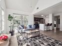 Open-concept living room with a view into a kitchen and a large indoor plant at 6755 S Ivy St # A7, Centennial, CO 80112