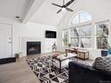 Living room with a fireplace, high ceilings and many windows letting in natural light at 6755 S Ivy St # A7, Centennial, CO 80112