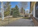 Private patio area surrounded by mature trees and a fenced backyard at 9256 W Euclid Ave, Littleton, CO 80123