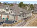 Charming home with a landscaped yard, two-car garage, mountain views, and sidewalk access at 13535 W 62Nd Ln, Arvada, CO 80004