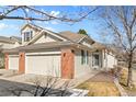 Charming home with a two-car garage, landscaped yard and sidewalk access at 13535 W 62Nd Ln, Arvada, CO 80004