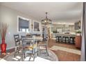 Bright dining area with hardwood floors and kitchen views at 11100 Haskell Creek Rd, Larkspur, CO 80118