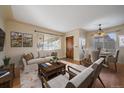 Open living and dining area with hardwood floors and lots of natural light at 4157 Perry St, Denver, CO 80212