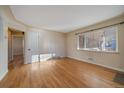 Bright living room featuring hardwood floors and large windows at 4157 Perry St, Denver, CO 80212