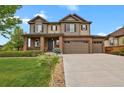Beautiful two-story home boasting a three-car garage, manicured lawn, and impeccable curb appeal at 30 S Ider Way, Aurora, CO 80018