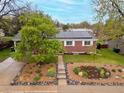 An eye-level view shows the home with its solar panels, attractive landscaping, driveway, and surrounding neighborhood at 3379 W Wagon Trail Dr, Englewood, CO 80110
