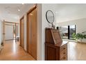 Light-filled hallway featuring hardwood floors and closet space and a nook with an antique desk at 330 Ptarmigan St, Golden, CO 80403