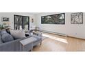 Bright living room with hardwood floors, modern furniture, and a large window offering natural light at 330 Ptarmigan St, Golden, CO 80403