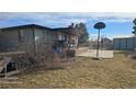 Backyard featuring a covered patio, concrete landing, and space for outdoor recreation at 15600 E 33Rd Pl, Aurora, CO 80011