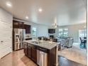 Open kitchen featuring granite countertops, stainless steel appliances, and hardwood flooring at 22466 E Layton Cir, Aurora, CO 80015