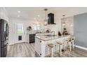 Bright kitchen features modern appliances, a central island with seating, and stylish backsplash tiles at 1599 S Telluride St, Aurora, CO 80017