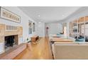 Bright living room featuring a fireplace, hardwood floors, and modern furnishings at 3198 W Amherst Ave, Denver, CO 80236