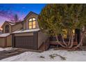 Two-story house with brown garage door and deck, snowy yard at 9883 Independence St, Broomfield, CO 80021