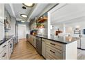 Beautiful updated kitchen with stainless steel appliances, open shelving, and breakfast bar at 7877 E Mississippi Ave # 1008, Denver, CO 80247