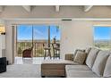 Cozy living room with a scenic view, comfortable seating and an adjacent sunroom for relaxation at 7877 E Mississippi Ave # 1008, Denver, CO 80247