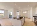 Open kitchen featuring large island with sink, stainless appliances, and natural light at 6719 Juniper Dr, Thornton, CO 80602