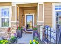 Inviting front entrance with a decorative door, stone accents, and vibrant potted plants creating curb appeal at 3751 W 136Th Ave # F4, Broomfield, CO 80023
