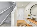 Inviting entryway with wood floors and stairs to upper level at 7946 S Kittredge St, Englewood, CO 80112