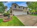 Two-story townhome with attached two-car garage and well-manicured lawn at 7946 S Kittredge St, Englewood, CO 80112