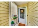 Cozy front porch with decorative wreath and potted flowers at 7946 S Kittredge St, Englewood, CO 80112