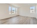 Bright living room featuring hardwood floors and large windows at 39610 Congress Ln, Elizabeth, CO 80107