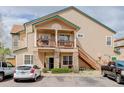 Charming condo featuring stone accents, a private balcony, and well-maintained landscaping at 3993 S Dillon Way # 104, Aurora, CO 80014