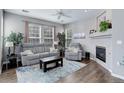 Comfortable living room features a plush sofa set, fireplace, and large windows at 3993 S Dillon Way # 104, Aurora, CO 80014
