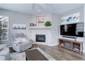 Comfortable living room with a decorative fireplace, modern TV setup, and a cozy gray recliner at 3993 S Dillon Way # 104, Aurora, CO 80014