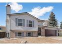 Charming two-story home with attached garage, chimney, and mature landscaping at 4025 S Fundy Way, Aurora, CO 80013