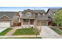 Inviting two-story home with a well-manicured lawn and a spacious two-car garage at 16685 E 101St Ave, Commerce City, CO 80022