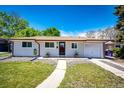 Well maintained front yard and walkway of single story home with attached one car garage at 1183 S Umatilla St, Denver, CO 80223